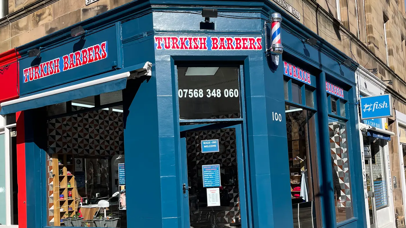 Marchmont Turkish Barbers — blue corner shopfront with barber pole, 100 Marchmont Road