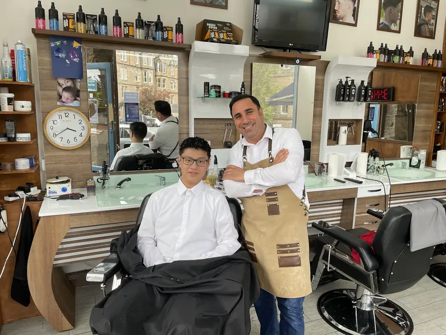 Owner Vedat with a happy customer inside the shop